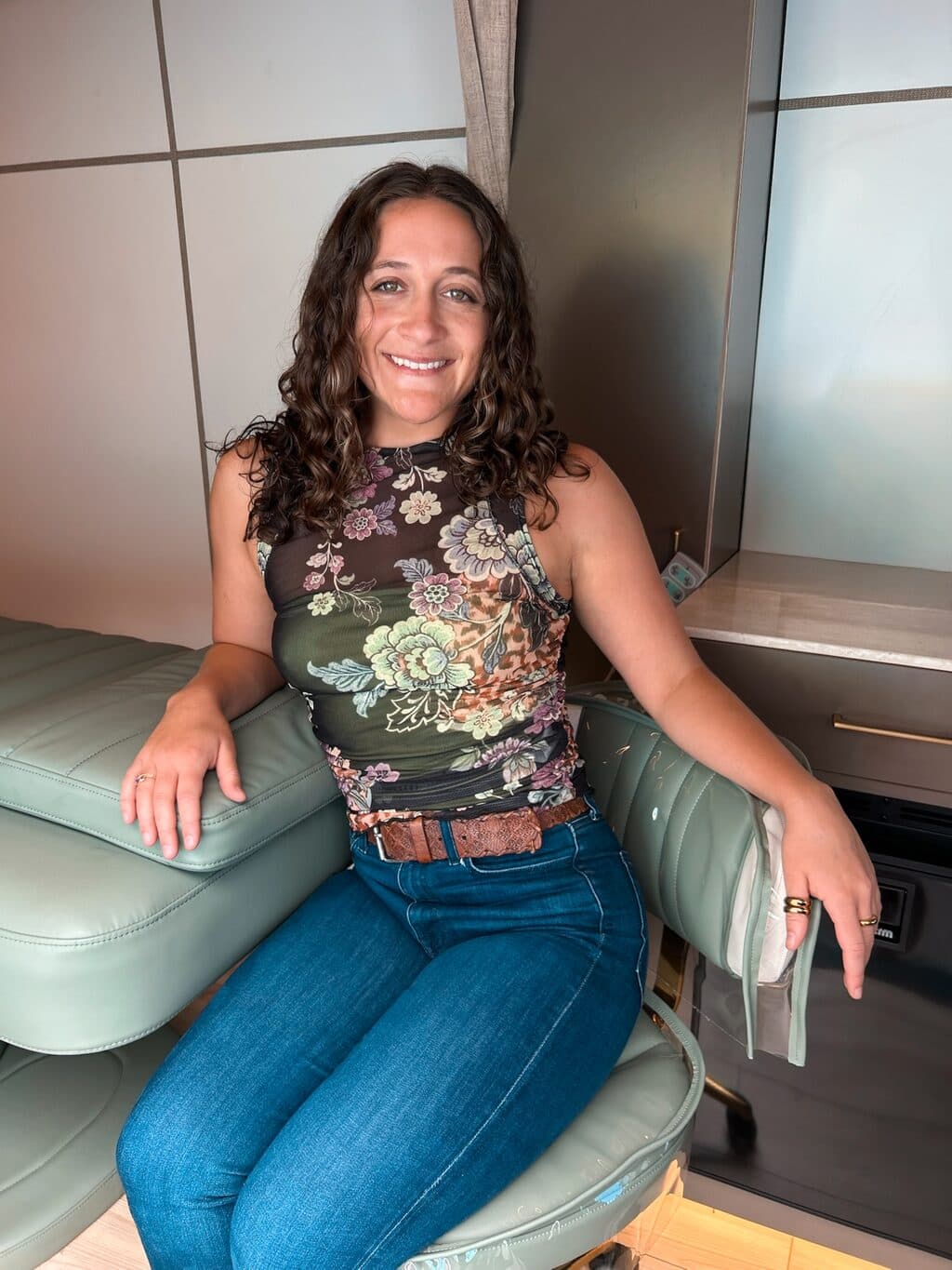 Ashley smiling in the treatment chair inside The Babe Bus